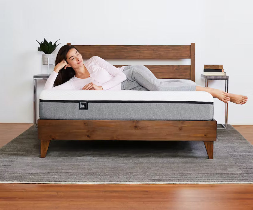 A woman comfortably laying across a lull mattress.