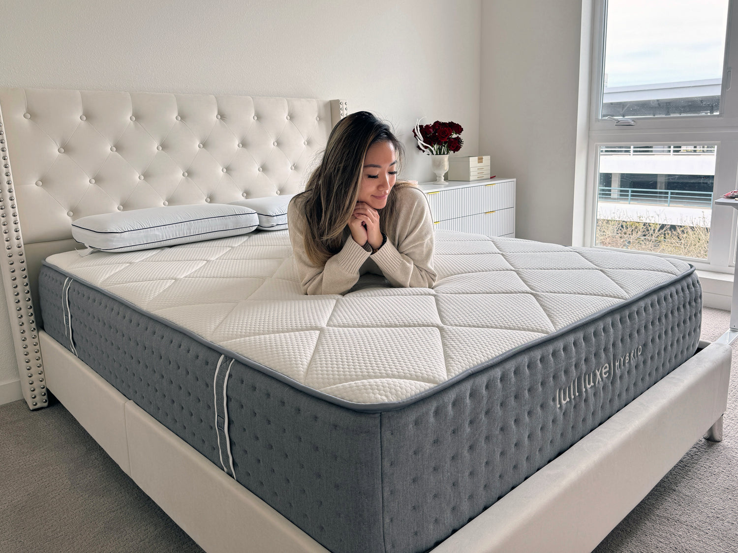 A picture of a woman on a Lull mattress.