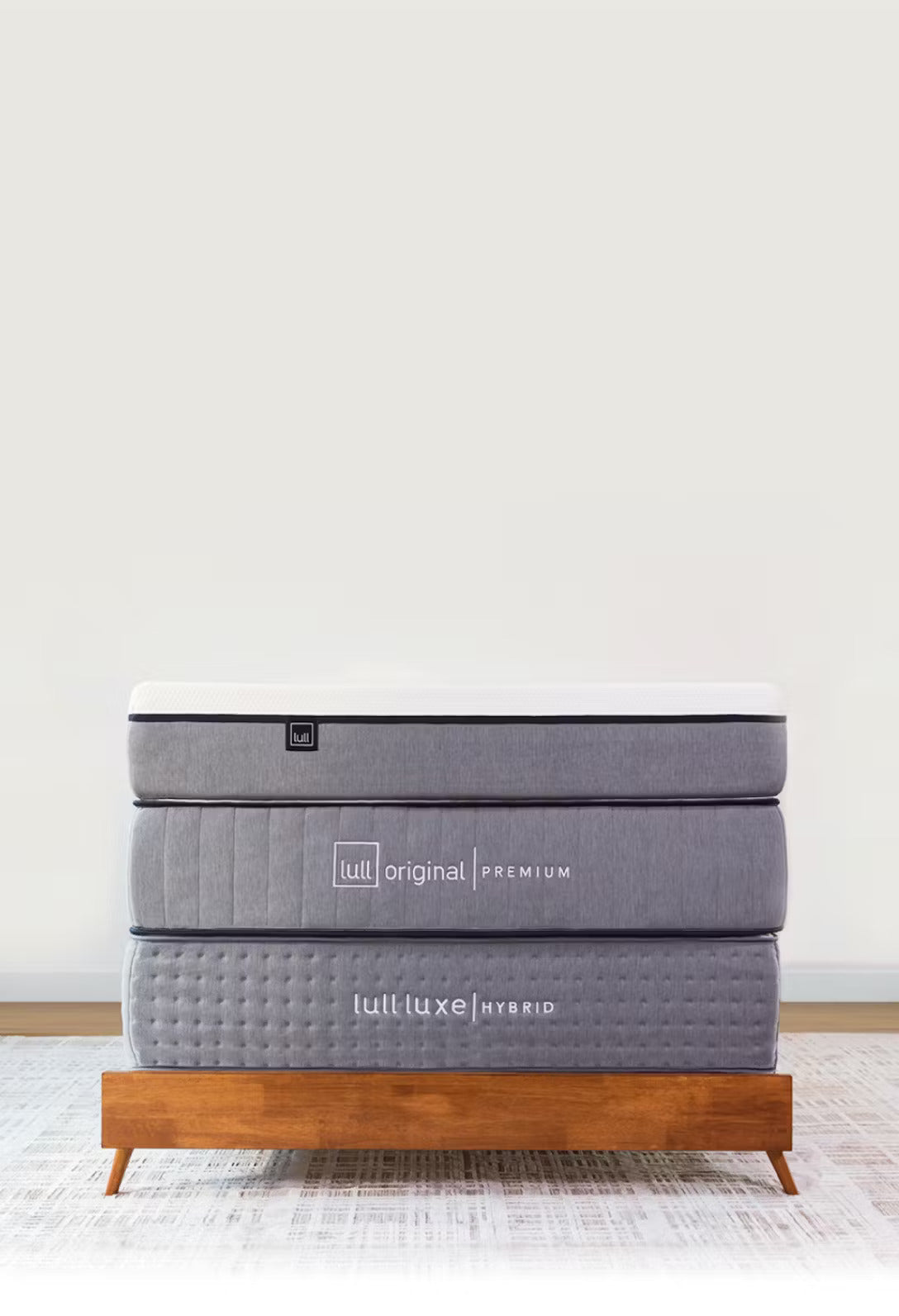 A photo of Lull's 3 award winning mattress stacked on top of each other.