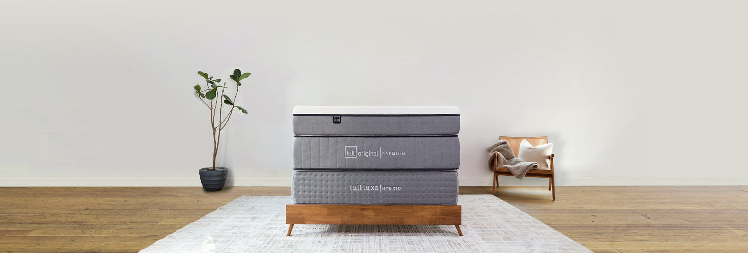 Lull's three award winning mattresses stacked on top of each other in a bedroom.