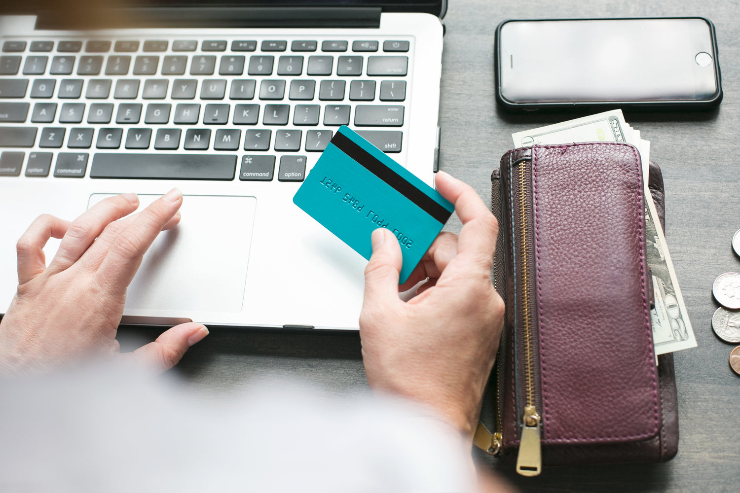 A person holding a credit card ready to make a purchase online.