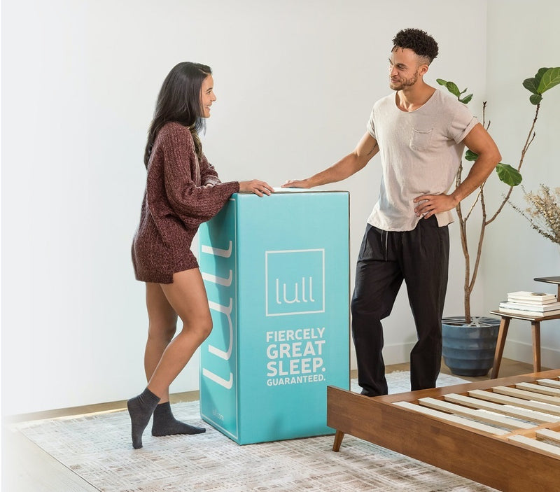 A couple looking at a lull mattress boxed up.