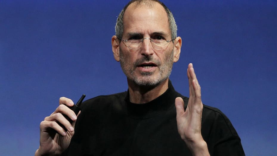 A picture of Steve Jobs talking at a conference in a black shirt.