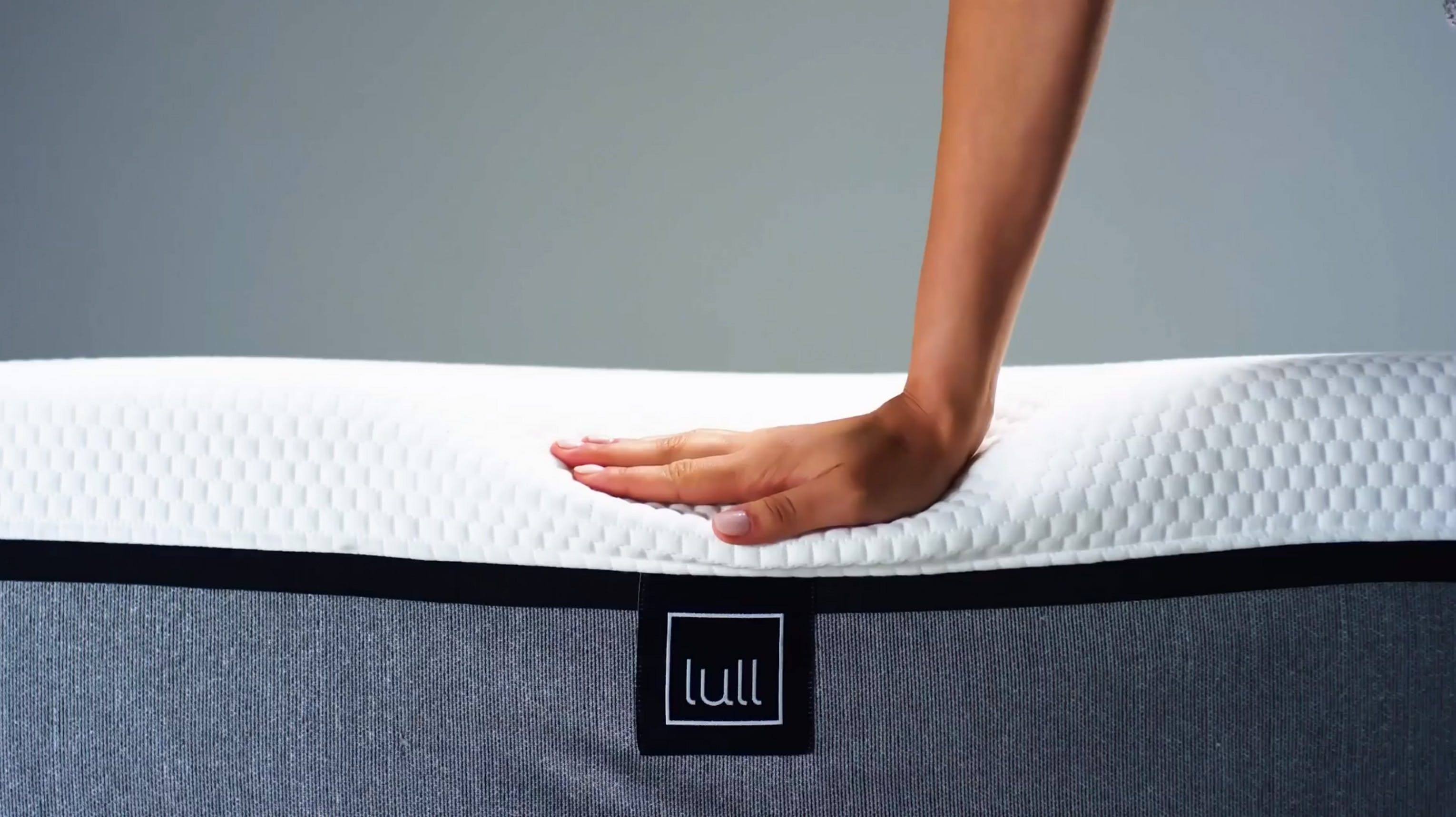 Load video: A woman smiling showcasing her lull mattress.