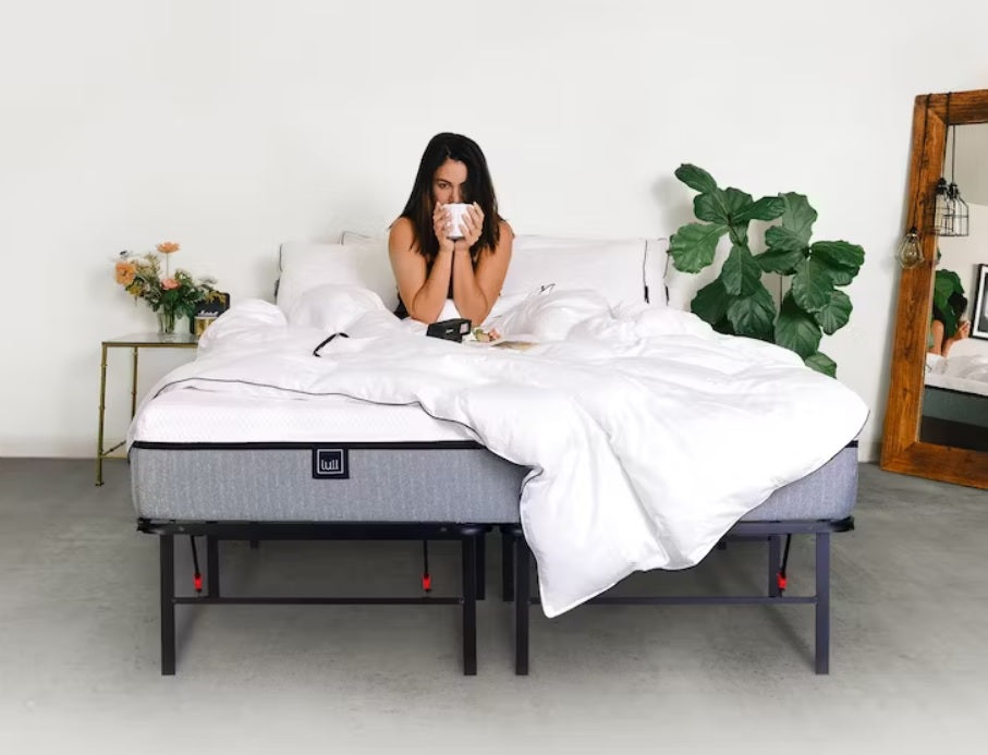 Woman drinking coffee on an Original Lull Mattress and Arrellaga frame