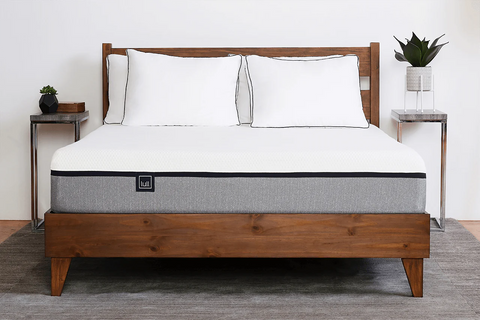 Original Lull Mattress on a wooden bed frame with pillows in a bedroom setting