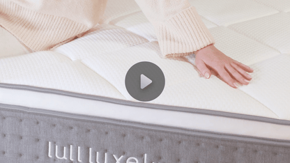 A video of a woman very comfy on a lull mattress.