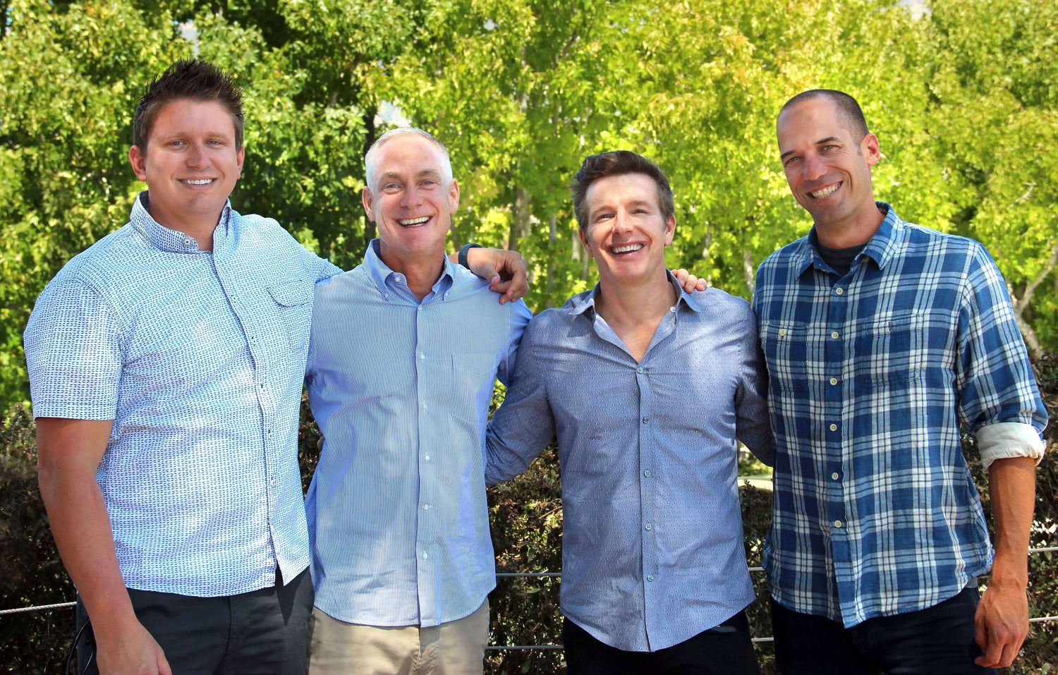 Lulls four founders smiling in a bright natural outdoor setting.