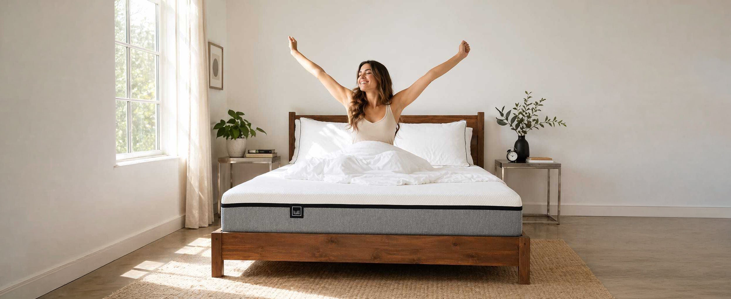 Woman stretching happily on a Lull memory foam mattress with Lull logo visible